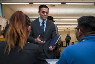 Veteran Cuong Pham speaks with employers from the Bureau of Reclamation during a military veterans job fair at the Vegas PBS campus on Wednesday, Oct. 25, 2017.  Pham recently separated from the U.S. Air Force in July and is currently exploring opportunities.