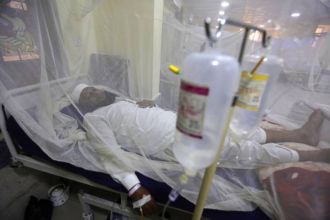 In this Thursday, Oct. 19, 2017 file photo, a patient suffering from dengue fever lies in a hospital bed in Peshawar, Pakistan. Cases of dengue fever — a painful mosquito-borne spread disease — have doubled every decade since 1990 with 58.4 million cases and 10,000 deaths in 2013. Dr. Howard Frumkin, a former environmental health director at the U.S. Centers for Disease Control and Prevention, said climate change, which allows mosquitoes to live in more places and stay active longer with shorter freeze seasons, is part but not all of the reason. 
