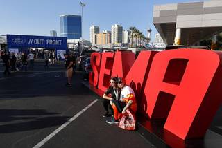 Stefanie Prickett-Taylor and Wes Taylor of Spring, Texas pose for a photo during the 2017 Specialty Equipment Market Association (SEMA) show at the Las Vegas Convention Center Tuesday, Oct. 31, 2017. The show is expected to attract about 140,000 attendees, according to a show representative.