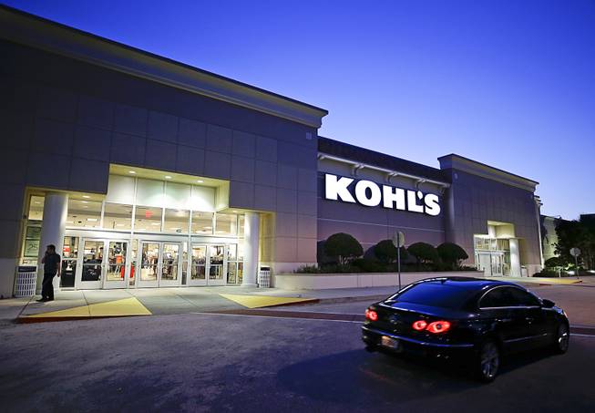 In this Tuesday, Aug. 22, 2017, photo, a car drives by the entrance of a Kohl's department store in Orlando, Fla. Retailers are trying to step up their game online and in person for the winter holidays, from dangling more discounts to livening up their stores. Kohl's says it's trying to woo new customers by making it more simple to shop, including being more clear about possible savings.