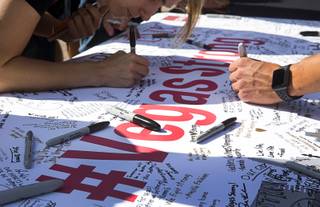 Students sign a #Vegas Strong banner during a remembrance ceremony at UNLV Thursday, Nov. 2, 2017. The event was held to honor those from the UNLV family who lost their lives or were injured during the Oct. 1 mass shooting on the Las Vegas Strip.