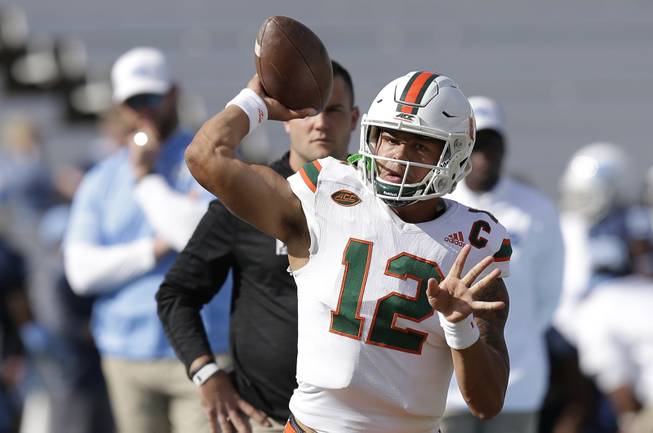 Miami quarterback Malik Rosier (12) passes prior to an NCAA college football game against North Carolina in Chapel Hill, N.C., Saturday, Oct. 28, 2017. (AP Photo/Gerry Broome)