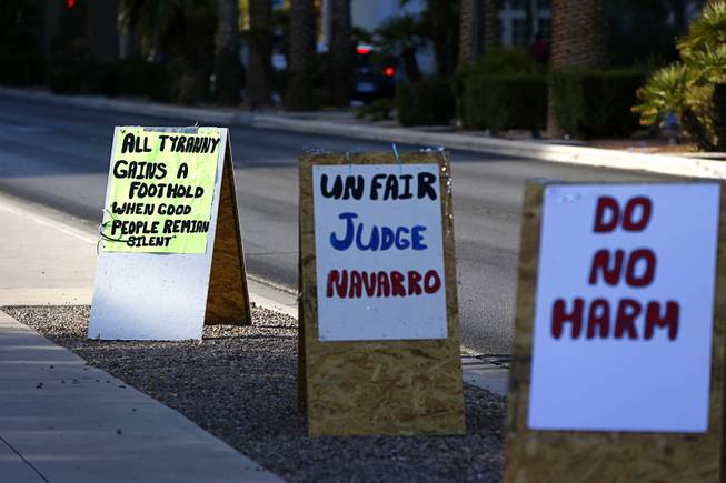 Signs, placed by supporters of rancher Cliven Bundy, are shown along Las Vegas Boulevard outside the federal courthouse in downtown Las Vegas Tuesday, Nov. 7, 2017. The trial of rancher Cliven Bundy, two of his sons, and Ryan Payne was postponed for a week.
