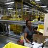 Myrtice Harris packages products for shipment at an Amazon fulfillment center in Baltimore in August. The company plans to hire 25,000 veterans in the next five years.