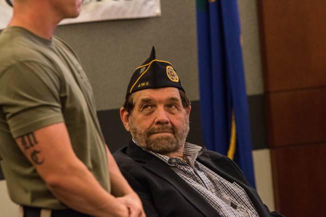 Nevada Supreme Court Chief Justice Michael Cherry, right, looks on as U.S. Marines veteran Erik Georgi, left, is introduced during Veterans Treatment Court graduation ceremony on Oct. 25, 2017. Georgi was presented a certificate for his advancement in the program. 