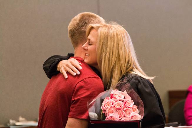 U.S. Navy veteran and Veterans Treatment Court graduate, Nathan Sexton, hugs Las Vegas Justice Court Judge Melissa Saragosa during a ceremony on Oct. 25, 2017. 