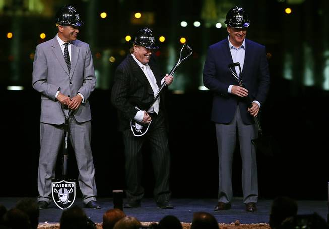 Raiders owner Mark Davis, center, uses his shovel as an air guitar during a groundbreaking ceremony with Nevada Governor Brian Sandoval, left,  and NFL Commissioner Roger Goodell for the $1.9 billion Raiders stadium near the Las Vegas Strip Monday, Nov. 13, 2017.