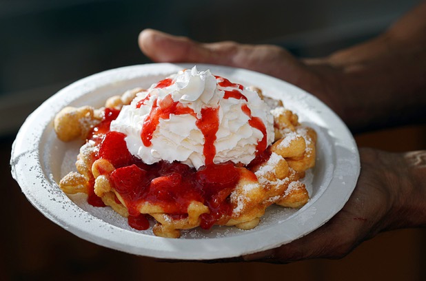 Elbert Braud displays a strawberry funnel cake at Braud's Funnel Cake Cafe in Town Square Las Vegas Monday, Nov. 13, 2017.