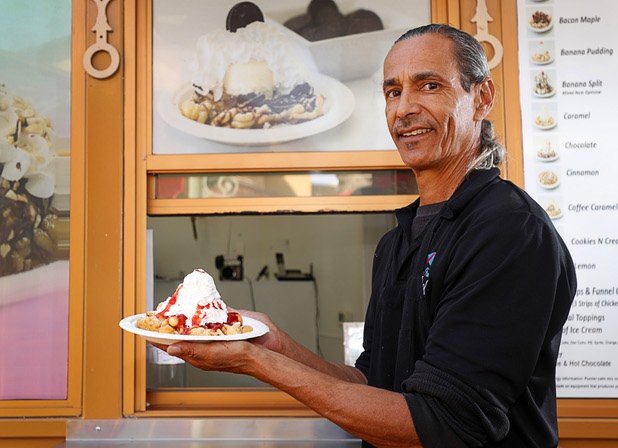 Elbert Braud displays a strawberry funnel cake at Braud's Funnel Cake Cafe in Town Square Las Vegas Monday, Nov. 13, 2017.