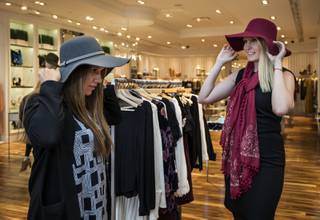 Customers Chantal Rodrigues and Halee Harczynski try on hats and scarves at Jolene's in their Downtown Summerlin store, shoppers now rediscovering the brick-and-mortar retail experience on Tuesday, Nov. 14, 2017.   L.E. Baskow.