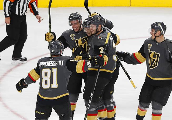 Golden Knights players celebrate their third goal during a game against the Los Angeles Kings at T-Mobile Arena Sunday, Nov. 19, 2017.