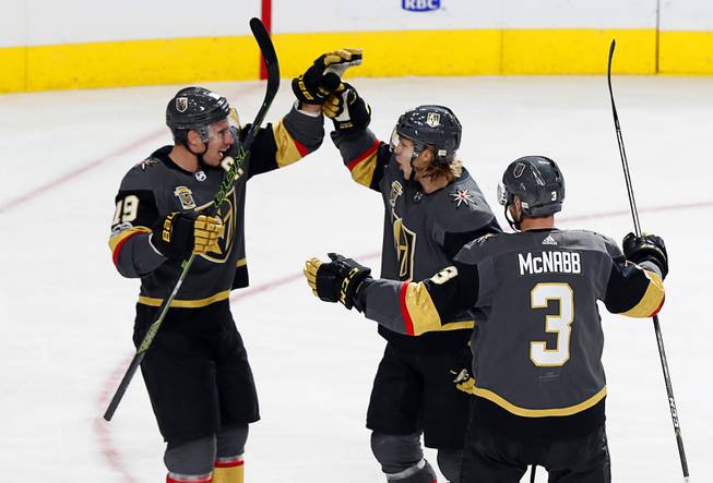 Vegas Golden Knights center William Karlsson, center, (71) celebrates with right wing Reilly Smith (19) and defenseman Brayden McNabb (3) after scoring his second goal of the first period during a game against the Los Angeles Kings at T-Mobile Arena Sunday, Nov. 19, 2017. The goal put the Golden Knights ahead 3-0 in the first period.
