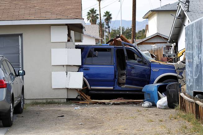 A Ford Expedition SUV is shown after crashing though a home garage in a neighborhood near Washington Avenue and Torrey Pines Drive Monday morning, Nov. 20, 2017.