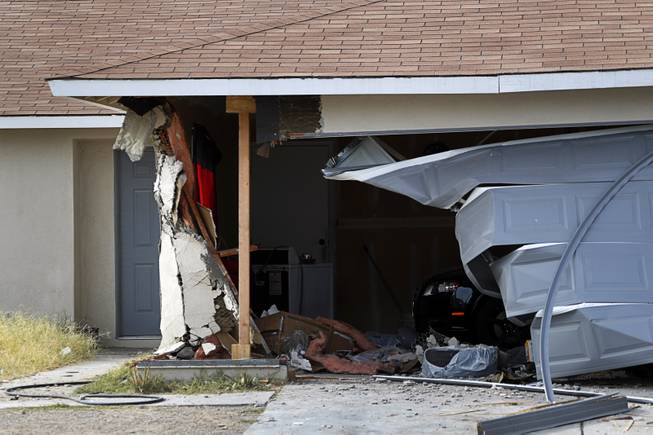 A view of a garage after a Ford Expedition SUV crashed into a home in a neighborhood near Washington Avenue and Torrey Pines Drive Monday morning, Nov. 20, 2017.