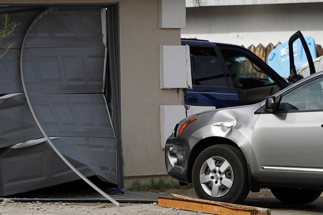 Car that was parked outside of the garage was also damaged by debris after a Ford Expedition SUV crashed into a home in a neighborhood near Washington Avenue and Torrey Pines Drive Monday morning, Nov. 20, 2017.