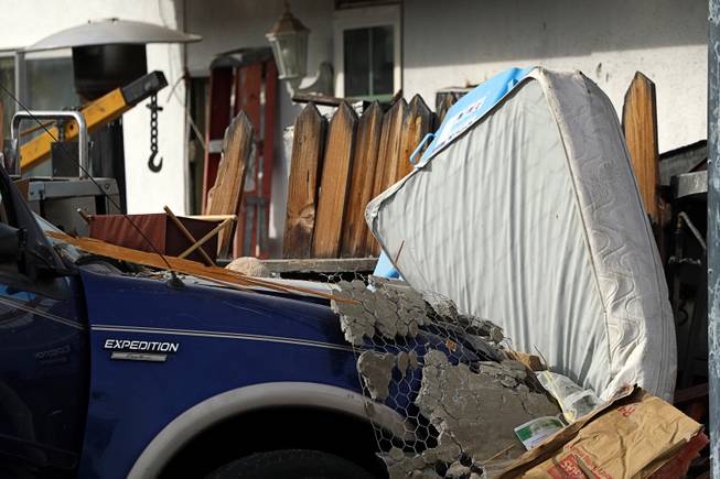 A mattress that was stored in the garage is shown between  a Ford Expedition and a neighboring fence after the SUV crashed into a home in a neighborhood near Washington Avenue and Torrey Pines Drive Monday morning, Nov. 20, 2017.