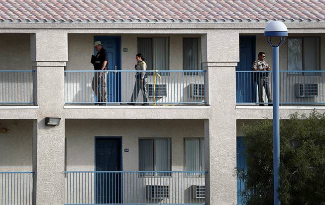 Metro officers and a crime scene analyst are shown near an apartment after a fatal stabbing at Budget Suites in the 8400 block of South Las Vegas Boulevard Monday, Nov. 20, 2017.