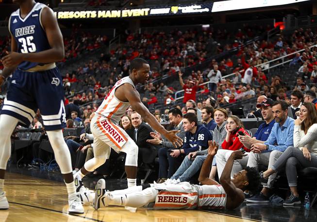 UNLV's Jovan Mooring (30), bottom, celebrates after sinking a 3-pointer and getting the foul during a game against the Rice Owls in the MGM International Main Event basketball tournament at T-Mobile Monday, Nov. 20, 2017.