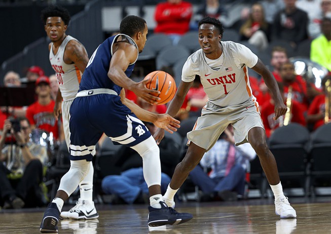 UNLV's Kris Clyburn (1) guards Rice's Connor Cashaw (0) during ...