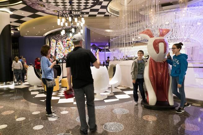 Guest take photos with a rabbit sculpture on the newly renovated second floor of The Chandelier bar— famous for its opulent crystal chandelier—at The Cosmopolitan during a preview tour, Monday, Nov. 20, 2017.  Renovations continue on other areas of the three-story bar.