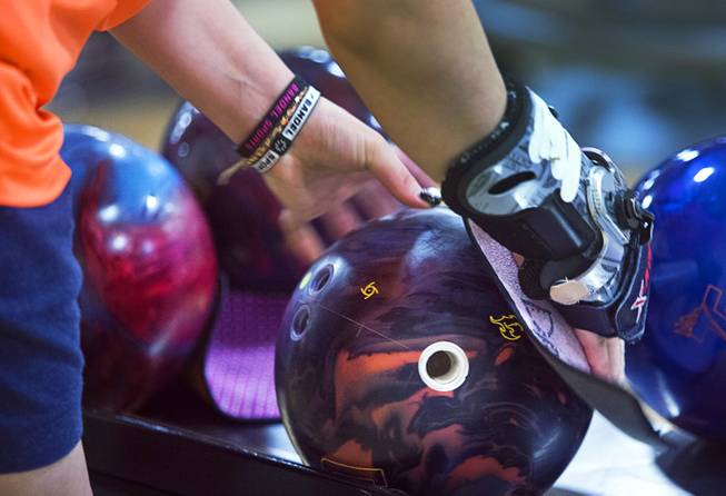 A Korean bowler cleans a ball during practice for the World Bowling Championships at the South Point Bowling Plaza Wednesday, Nov. 22, 2017. The tournament runs Nov. 23 though Dec. 4 and will feature 390 bowlers from 42 countries.