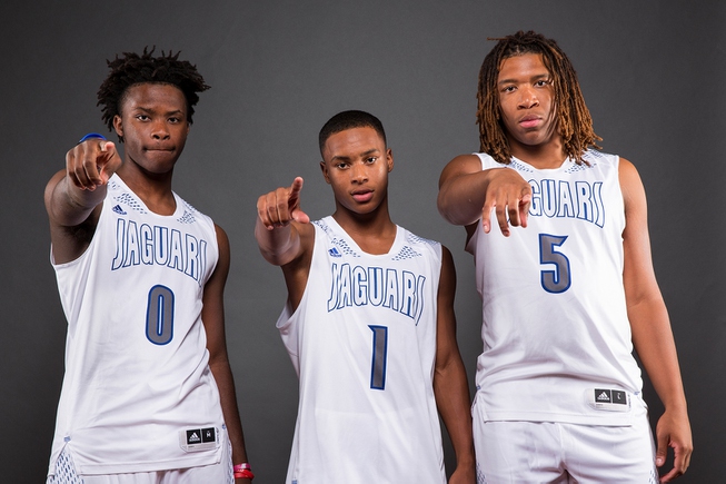 Players of the Desert Pines High basketball team, from left, ...