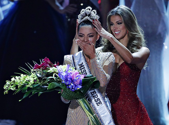 Former Miss Universe Iris Mittenaere, right, crowns new Miss Universe ...