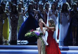 Former Miss Universe Iris Mittenaere, right, crowns new Miss Universe Demi-Leigh Nel-Peters at the Miss Universe pageant Sunday, Nov. 26, 2017, in Las Vegas.