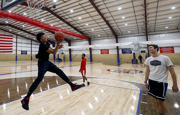 Planet Athlete students Piece Brown, left, 16, Felix Denis Jr., center, 17, and Anthony Cellentani practice in the Barn, a 30,000 sq. ft. field house, at the Rising Star Sports Ranch in Mesquite, Nev. Tuesday, Nov. 28, 2017.