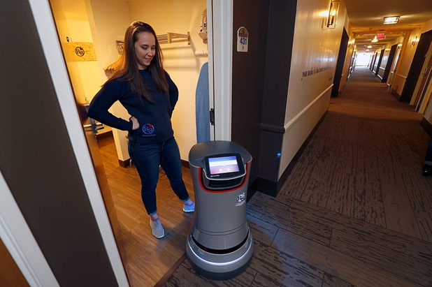 "Champ," a room service robot, leaves a room after a delivery to Jessica Martin, director of sports and events, at the Rising Star Sports Ranch in Mesquite, Nev. Tuesday, Nov. 28, 2017.  Food or delivery items are kept in a compartment at the top of the robot.