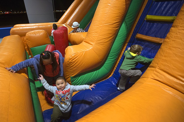 Children play in an inflatable obstacle course during a dealership debut for Subaru owners and employees at the new Subaru Las Vegas facility, a two-story building with 65,500 sq. ft. on Roy Horn Way between Rainbow and Jones boulevards, Wednesday, Nov. 29, 2017.