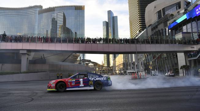 Monster Energy NASCAR Cup Series driver Jamie McMurray does a burnout at the intersection of the Strip and Harmon Avenue during the NASCAR Victory Lap being held as part of Champions Week Wednesday, November 29, 2017. CREDIT: Sam Morris/Las Vegas News Bureau