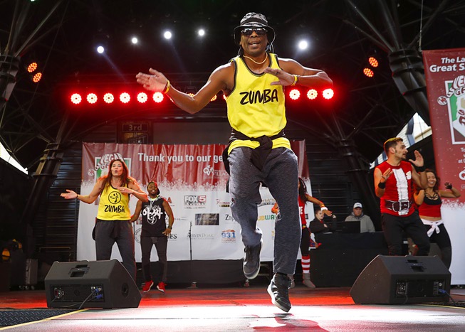 Zumba fitness instructor Jerry Johnson help warm up runners during ...