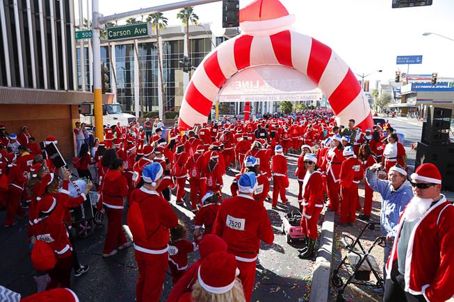 Runners head south on Las Vegas Boulevard at the start of the 13th annual Las Vegas Great Santa Run in downtown Las Vegas Saturday Dec. 2, 2017. More than 9,000 runners registered for the event, according to organizers. The annual run is a fundraiser for Opportunity Village.
