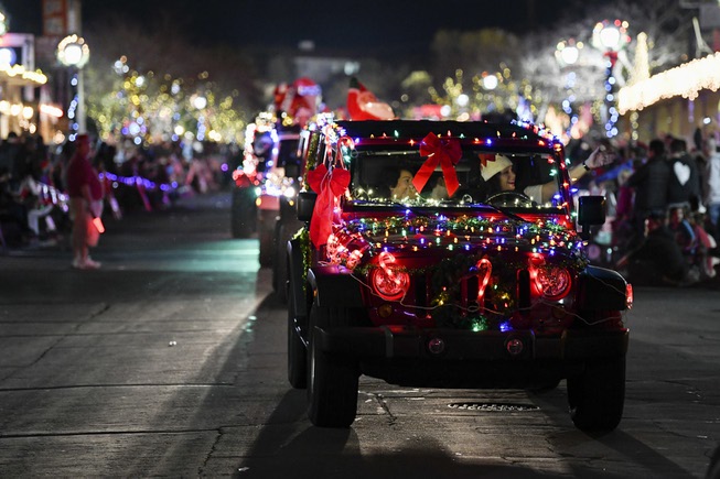 Decorated cars travel down Nevada Way during the Santa's Electric ...