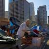 A man who identified himself just as Vincent, sorts his belongings outside his tent Friday, Dec. 1, 2017, in Los Angeles. Vincent said he thought he was bulletproof and never had to worry about getting a job as a young man. "Things ain't the way they were anymore." The U.S. Department on Housing and Urban Development release of the 2017 homeless numbers are expected to show a dramatic increase in the number of people lacking shelter along the West Coast. 