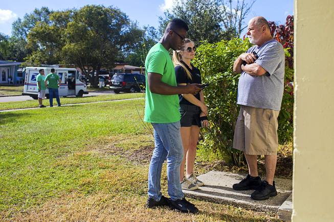Canvassers with Americans for Prosperity, the conservative group funded by the Koch brothers, discuss the Republican tax bill with residents of the Azalea Park neighborhood in Orlando, Fla., Dec. 2, 2017. Conservative groups are confronting the reality that most Americans are unconvinced that the tax bill will do much to help them. 