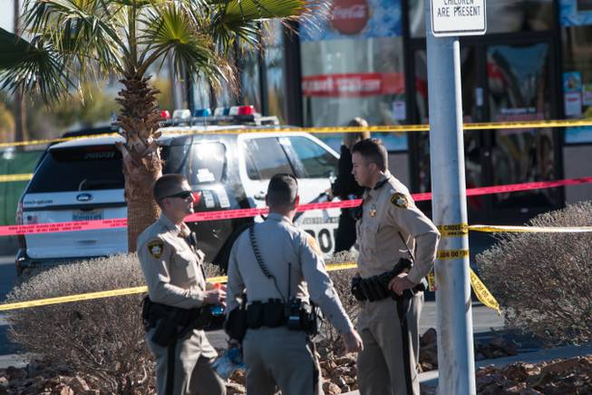 Metro Police investigate after an officer shot a bat-wielding suspect outside a central valley convenience store, Saturday, Dec. 9, 2017. 