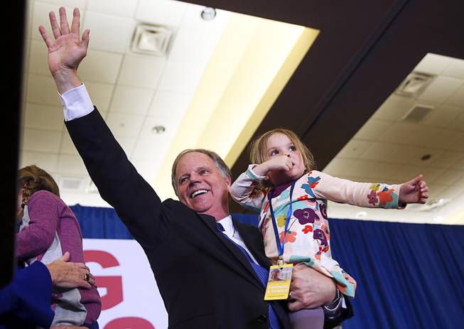 Doug Jones waves to supporters before speaking during an election-night watch party Tuesday, Dec. 12, 2017, in Birmingham, Ala. Jones won election to the U.S. Senate from Alabama, dealing a political blow to President Donald Trump. 