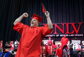 Lon Wilborn celebrates as he leaves the stage during the UNLV commencement ceremony at the Thomas & Mack Center Tuesday, Dec. 19, 2017.