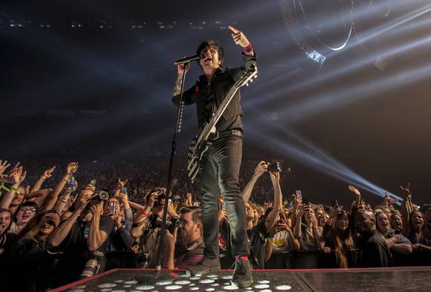 Green Day lead vocalist Billie Joe Armstrong sings before the crowd while performing at the MGM Grand Garden Arena on Friday, April 7, 2017.