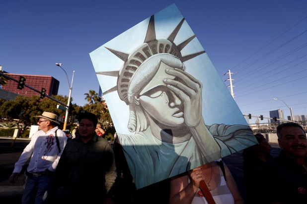 Esperansa Solorio holds a Statue of Liberty-themed sign as she marches on Flamingo Road Monday May 1, 2017. Thousands of union members and activists marched down the Las Vegas Strip before ending in a rally on Flamingo Road.