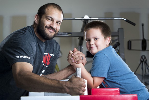 Armwrestler Jeff Alexander poses with his son Tyler, 5, in his garage gym Sunday, June 11, 2017. Alexander is training for the World Armwrestling League Amateur Championships being held June 30 at the House of Blues in Mandalay Bay.