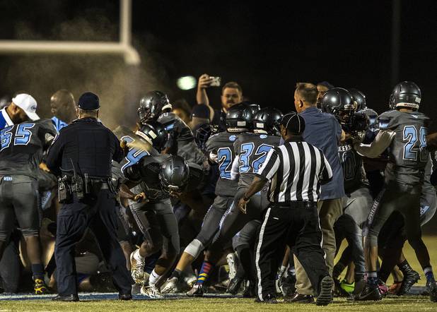 Basic and Canyon Springs players and coaches come to blows on the field as police move in with pepper spray following their game on Friday, September 15, 2017.
