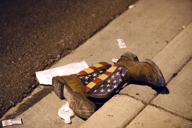 A pair of cowboy boots is shown in the street outside the concert venue after a mass shooting at a music festival on the Las Vegas Strip Sunday, Oct. 1, 2017.