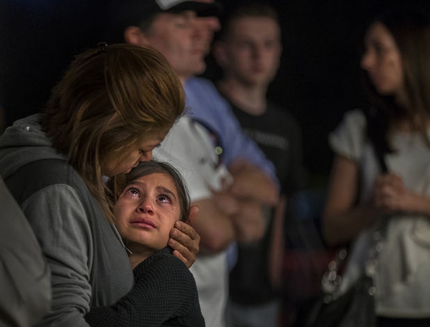 Janet Marchal comforts her daughter Celeste, 8, who weeps during a city of Las Vegas and Clark County prayer vigil for the victims of Sunday nights shooting on the Las Vegas Strip at Mountain Crest Park on Tuesday, October 3, 2017.   .