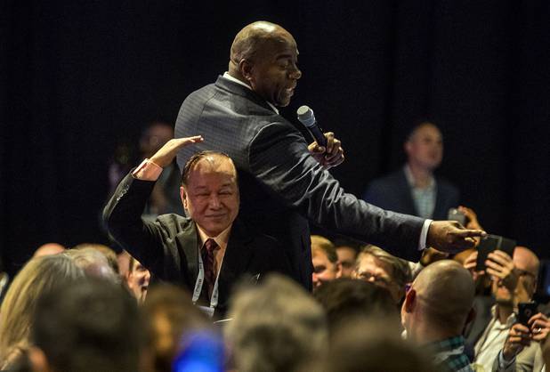 Magic Johnson jokes around with an attendee much smaller than him during his keynote address on personal success during the G2E at the Sands Expo on Thursday, October 5, 2017.   .
