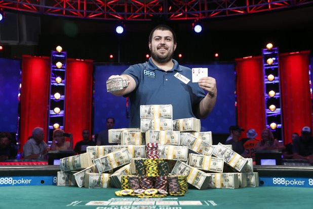 Scott Blumstein of the U.S. poses with his championship bracelet and cards after winning the World Series of Poker Main Event in Las Vegas, Nevada, U.S., July 23, 2017.