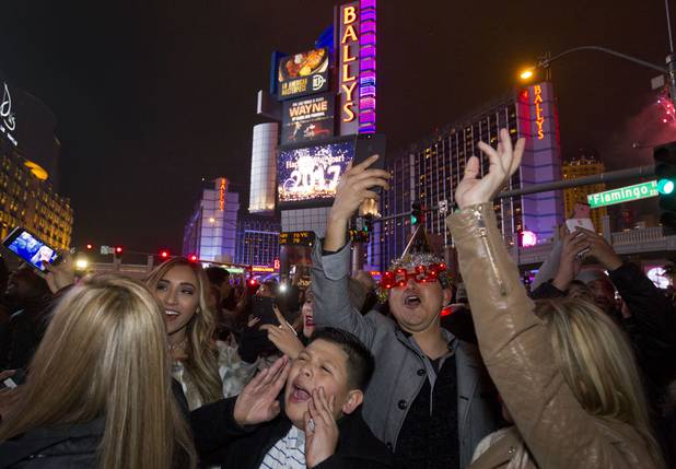 Revelers cheer in the intersection of Flamingo Road and the Las Vegas Strip on New Year's Eve Saturday, Dec. 31, 2016.