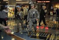 Through the weekend, travelers at McCarran International Airport and revelers on the Strip and downtown Las Vegas should notice an increase of armed National Guard personnel patrolling in their camouflage fatigues ...